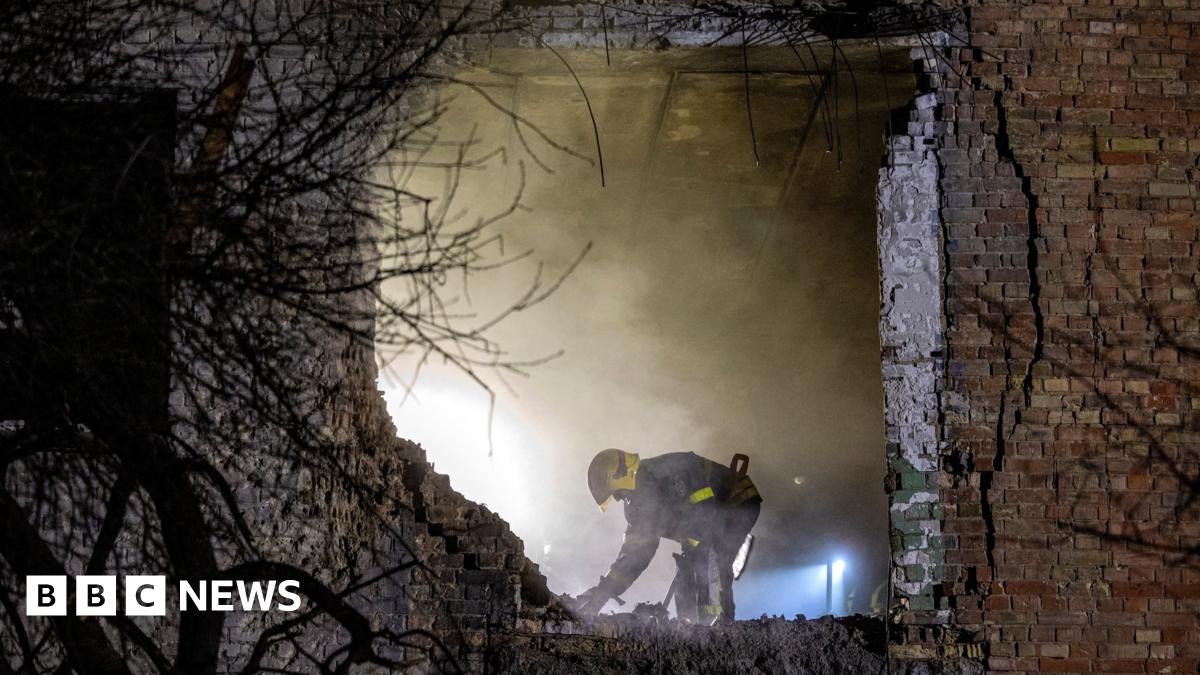An emergency responder works at the site of an apartment building that was hit during a Russian missile and drone attack on Kyiv on 29 November 2025.