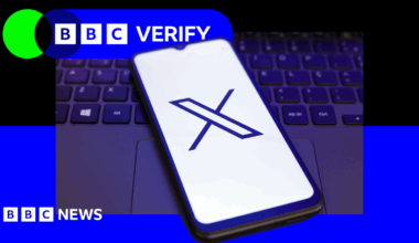 A mobile phone with the 'X' logo next to a laptop keyboard