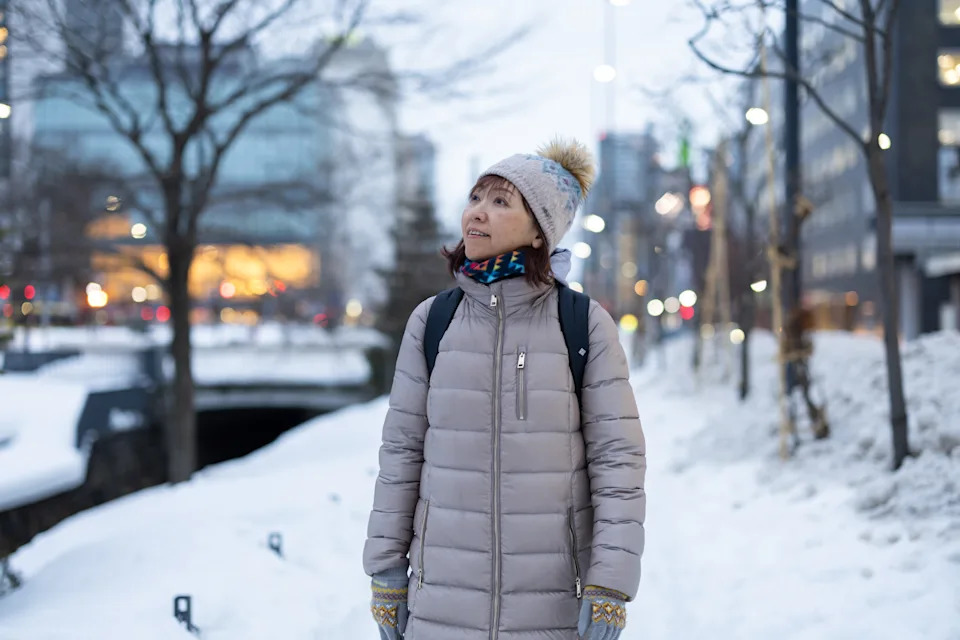 A woman enjoys looking at the scenery in a park she visited for sightseeing.
