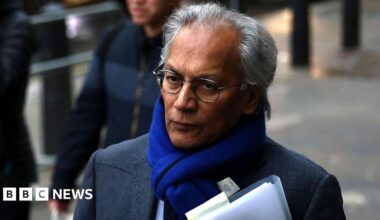 BBC chair Samir Shah walking down a street carrying a file