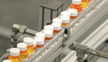 Bottles of medications ride on a belt at a mail-in pharmacy warehouse in Florence, N.J. on July 10, 2018.