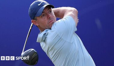 Rory McIlroy holds a golf club over his shoulder