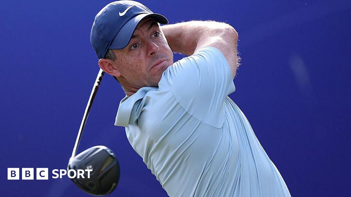 Rory McIlroy holds a golf club over his shoulder