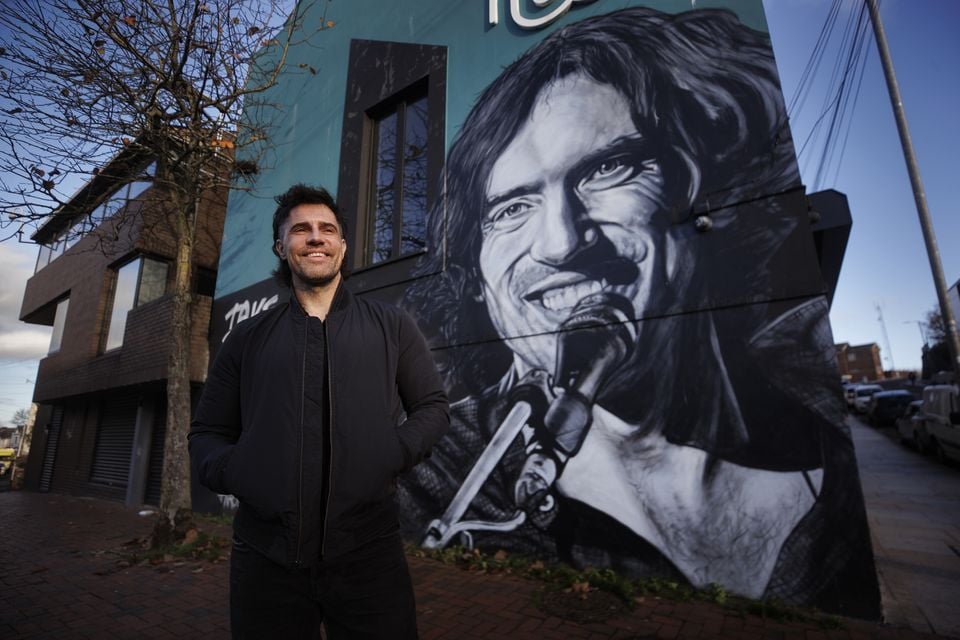 Johnny Hamilton in front of his Gary Lightbody mural in Bangor
