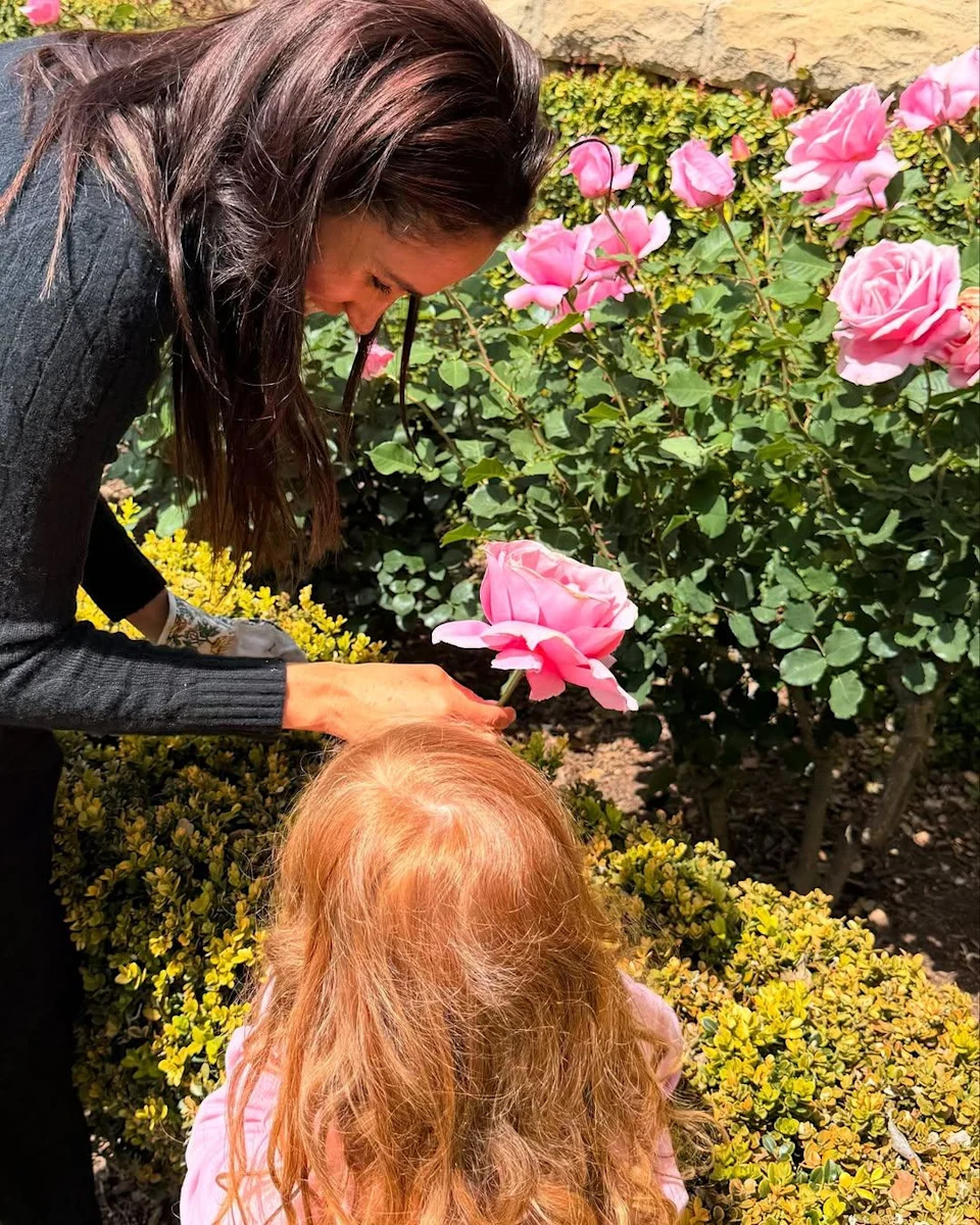 Meghan Markle and Princess Lilibet tend to a rose garden