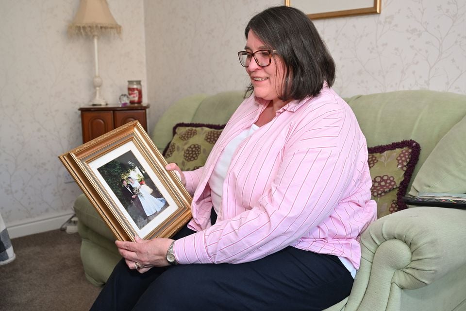 Ashley Reid holding a picture taken on her wedding day