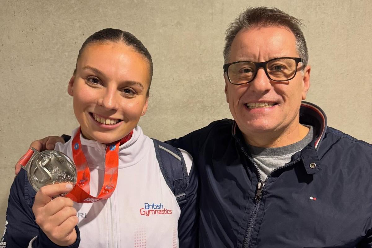 Alisha Evanson proudly wears her world championships team silver medal alongside her Cheshire Gymnastics coach Mark Hudson &lt;i&gt;(Image: Contributed)&lt;/i&gt;