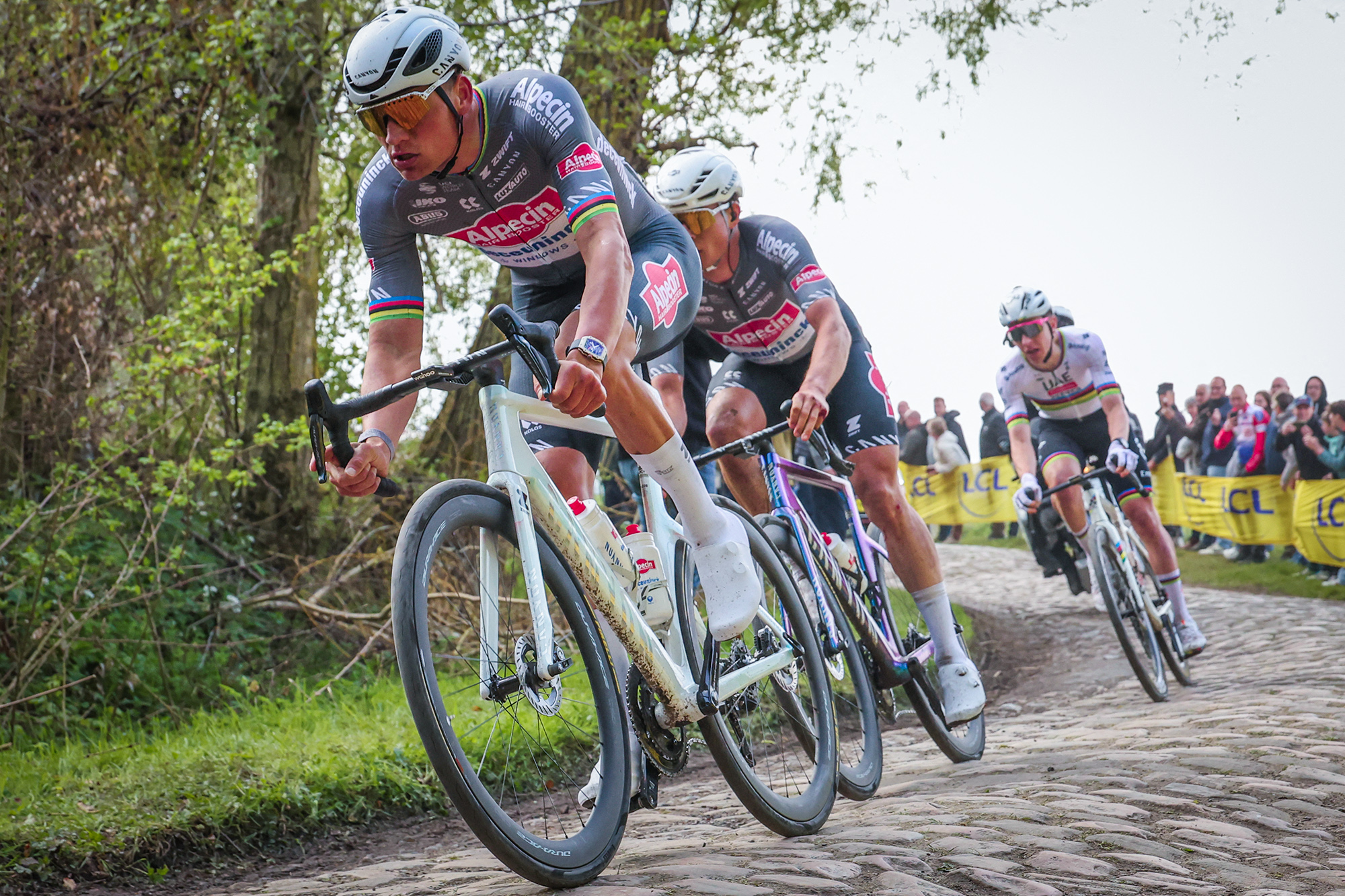 TOPSHOT - Alpecin-Deceuninck's Dutch rider Mathieu van der Poel (L), Alpecin-Deceuninck's Belgian rider Jasper Philipsen and UAE Team Emirates' Slovenian rider Tadej Pogacar (R) cycle in a breakaway on a cobblestone road during the 122nd edition of the Paris-Roubaix one-day classic cycling race, 259,2 km between Compiegne and Roubaix, northern France on April 13, 2025. (Photo by Francois LO PRESTI / AFP) (Photo by FRANCOIS LO PRESTI/AFP via Getty Images