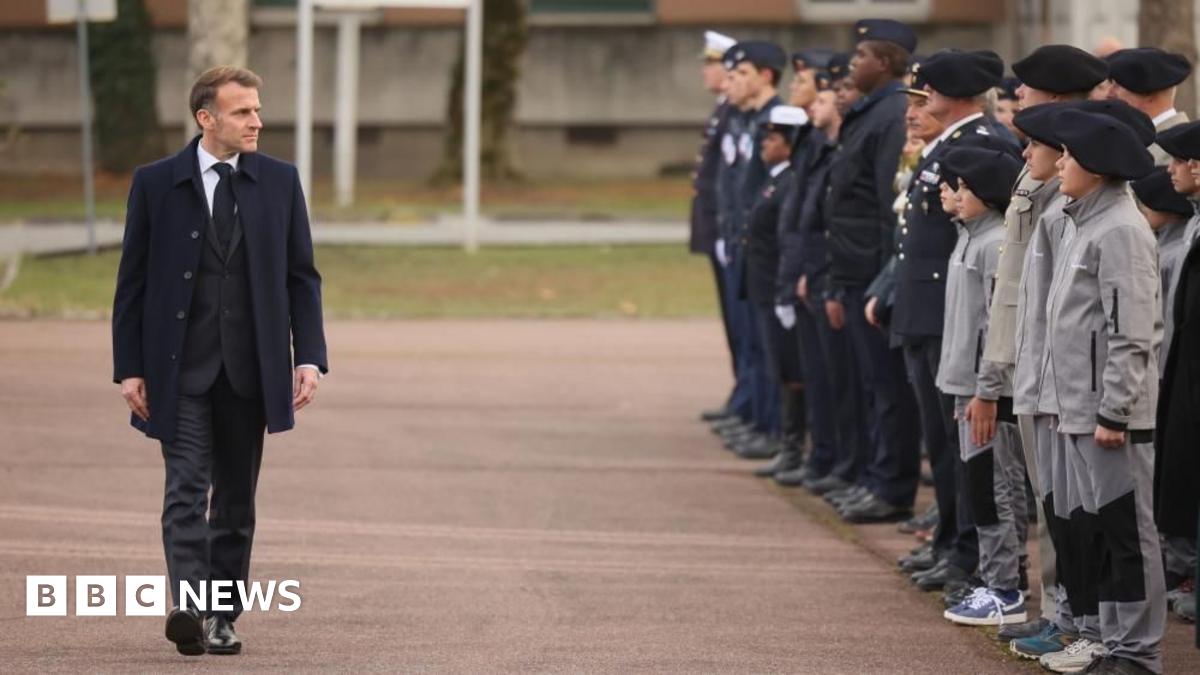 French President Emmanuel Macron reviews troops and students of an army high school prior to his speech to unveil a new national military service plan at the military base in Varces