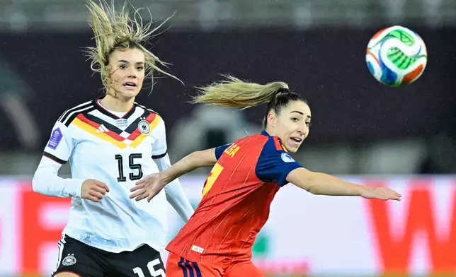 Germany's Selina Cerci, left, and Spain's Olga Carmona fight for the ball during the women's nations league soccer match between Germany and Spain in Kaiserslautern, Germany, Friday Nov. 28, 2025. (Uwe Anspach/dpa via AP)