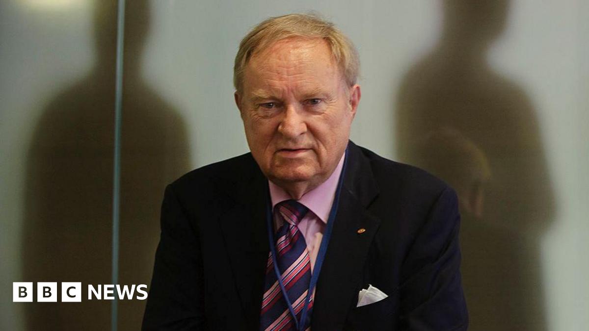 Ludwig Minelli, wearing a suit.