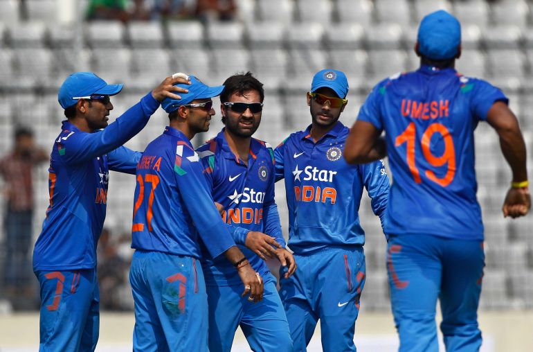India's Parvez Rasool, center, celebrates with his teammates the wicket of Bangladeshs captain Mushfiqur Rahim during their first one-day International cricket match in Dhaka, Bangladesh, Sunday, June 15, 2014. (AP Photo/A.M. Ahad)