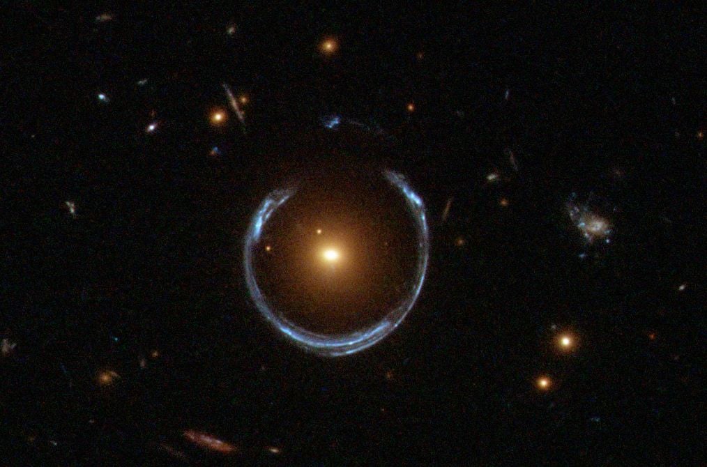 The gravity of a luminous red galaxy (LRG) has gravitationally distorted the light from a much more distant blue galaxy in a wonderful example of a gravitational lens (Credit : ESA/Hubble)
