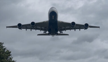 A large plane flying over Heathrow airport.