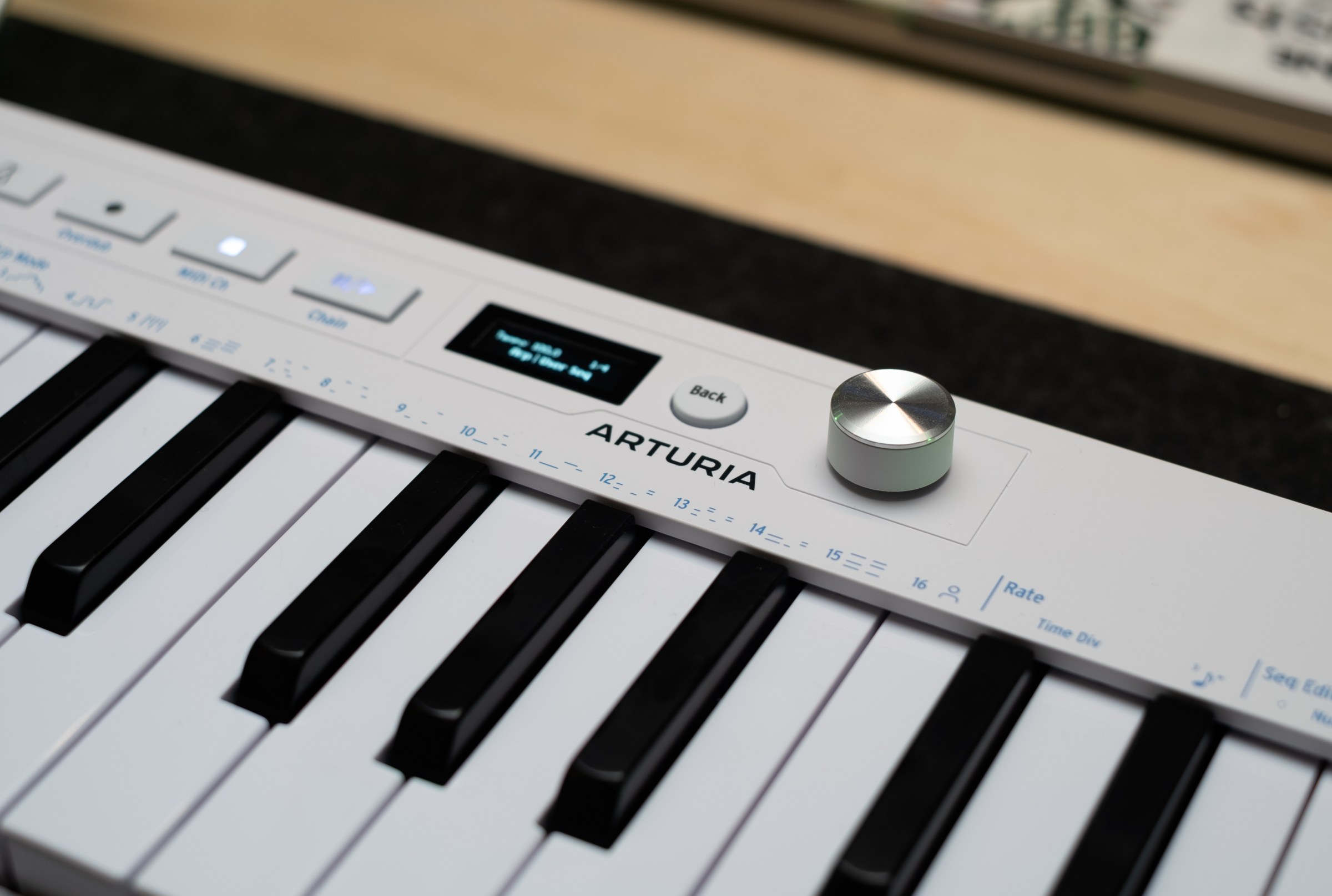 Close up of the Arturia logo alongside the new endless encoder and OLED on the KeyStep mk2.