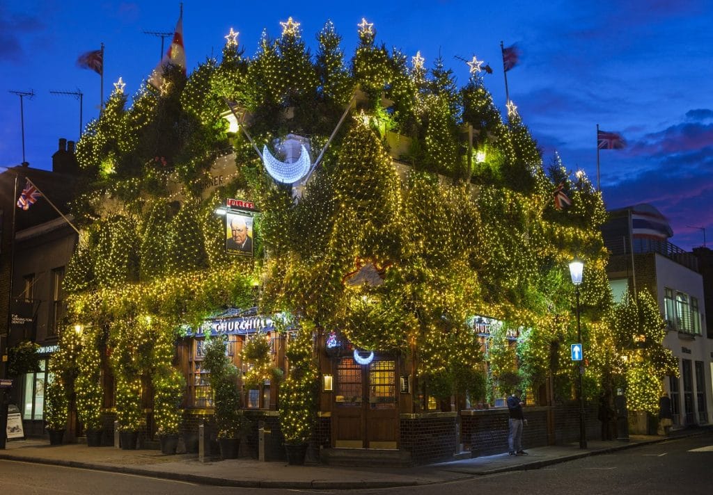 80 Christmas trees and thousands of lights glow on the exterior of The Churchill Arms pub in Kensington, London.