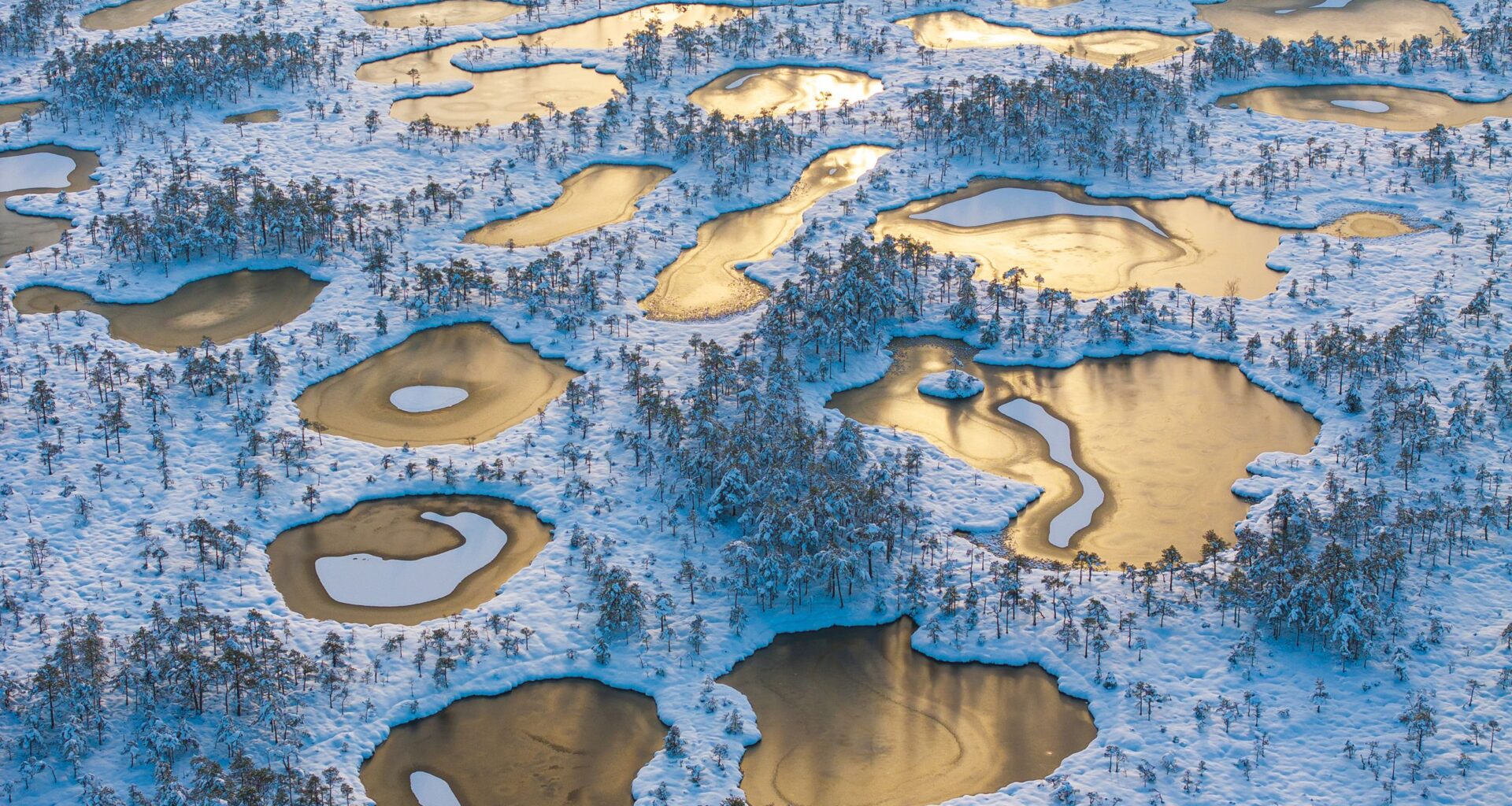 Expertly photographed with the DJI Mavic 3 Pro, this landscape of frozen peat pools looks like an ethereal, alien world