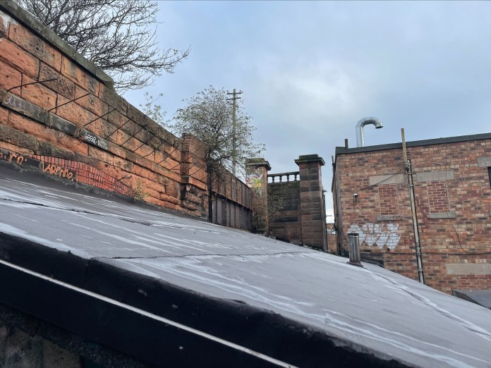 the vandals could have gained access to the rooftop and the old railway bridge through the car park of the housing development at Stead's Place (C) Deadline News
