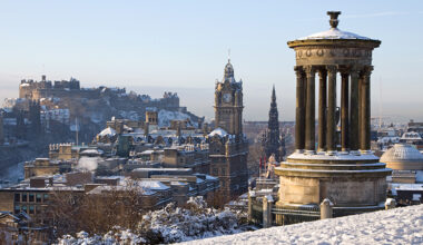Edinburgh City and Castle viewed from Calton Hill on a beautiful winter morning with the Dugald Stewart monument in the foreground and the castle, Scott monument and Balmoral clock tower in the background.