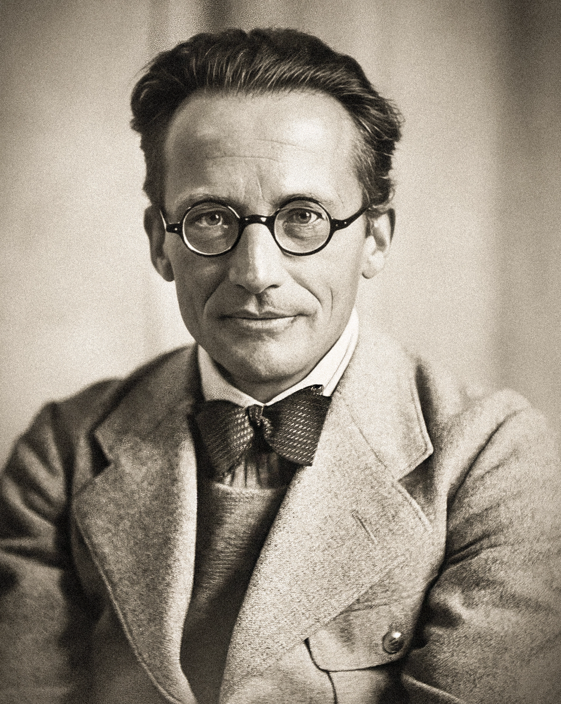 Black-and-white photo of a man in wire-frame glasses.