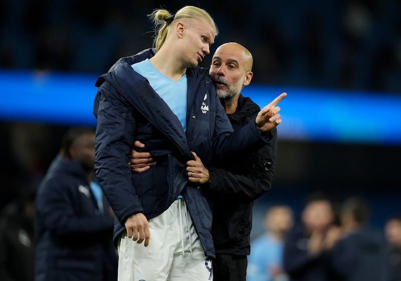 Pep Guardiola (right) speaks with Erling Haaland after the final whistle