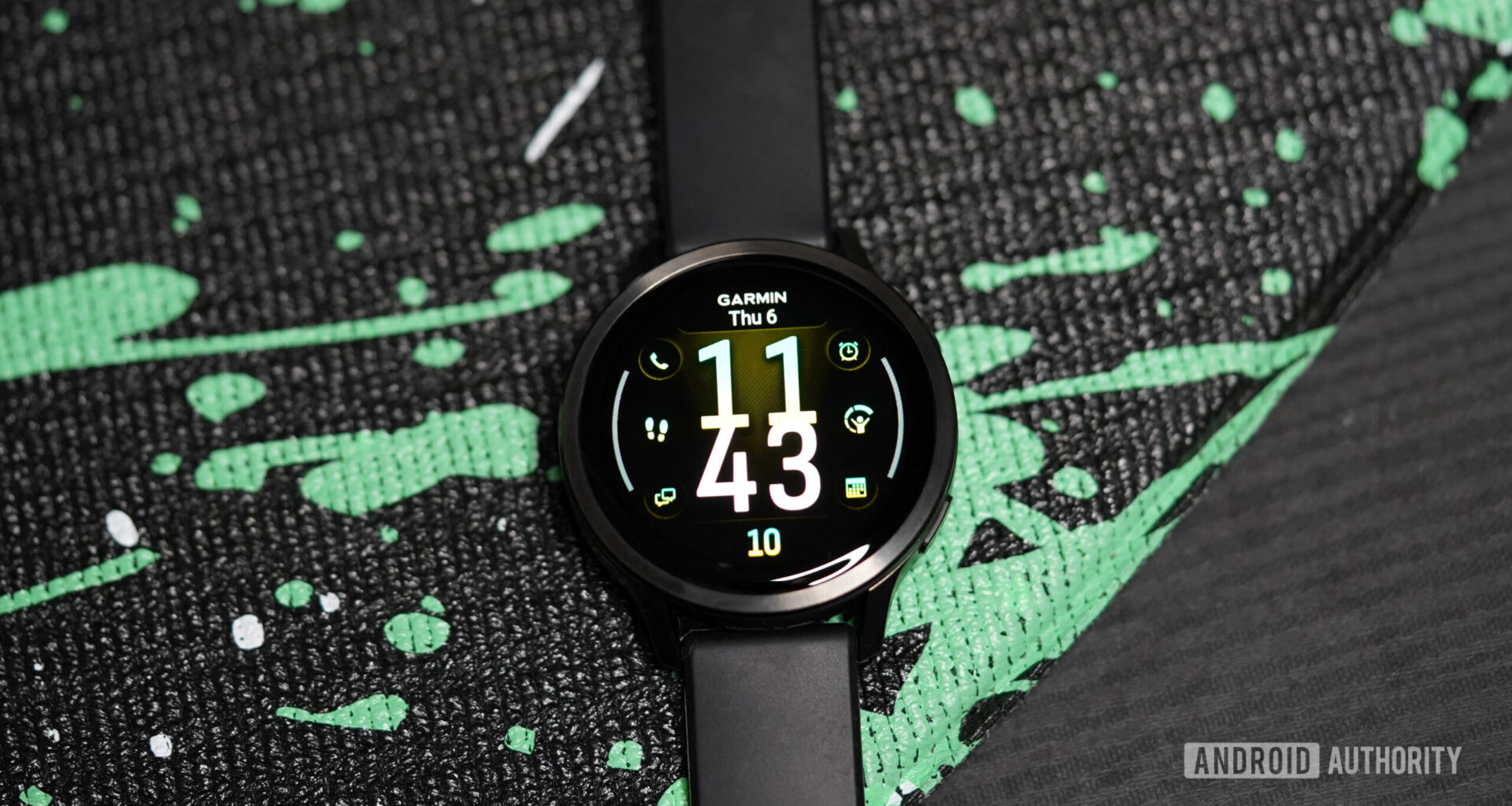 A Garmin Venu 4 displays a watch face.