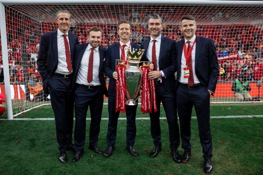 Liverpool's recruitment team including Michael Edwards and Richard Hughes hold the Premier League trophy.