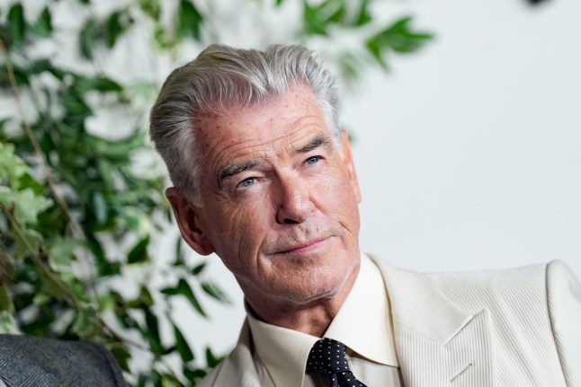 Pierce Brosnan at Netflix's The Thursday Murder Club premiere posing in a grey suit