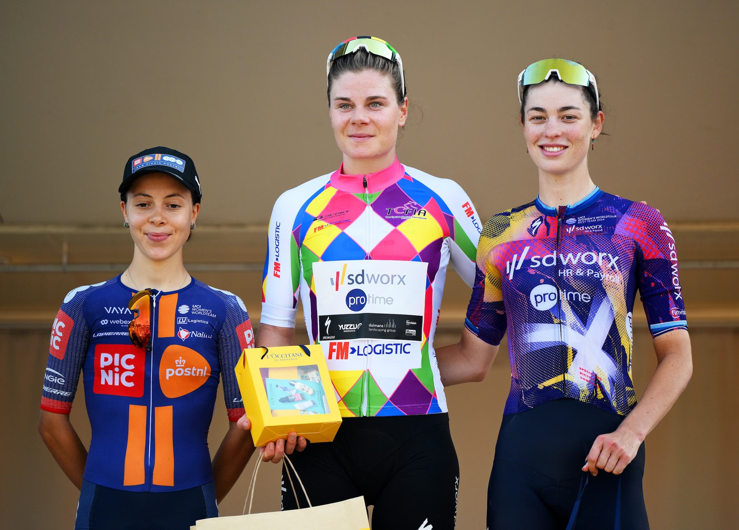 Eleonora Ciabocco (Team Picnic PostNL), race winner Lotte Kopecky (Team SD Worx - Protime) and Mischa Bredewold (Team SD Worx - Protime) on the podium after stage 1 of the Tour Cycliste Feminin International de l'Ardeche 2025, in Laudun-l’Ardoise, France (Photo: Alex Broadway/Getty Images)