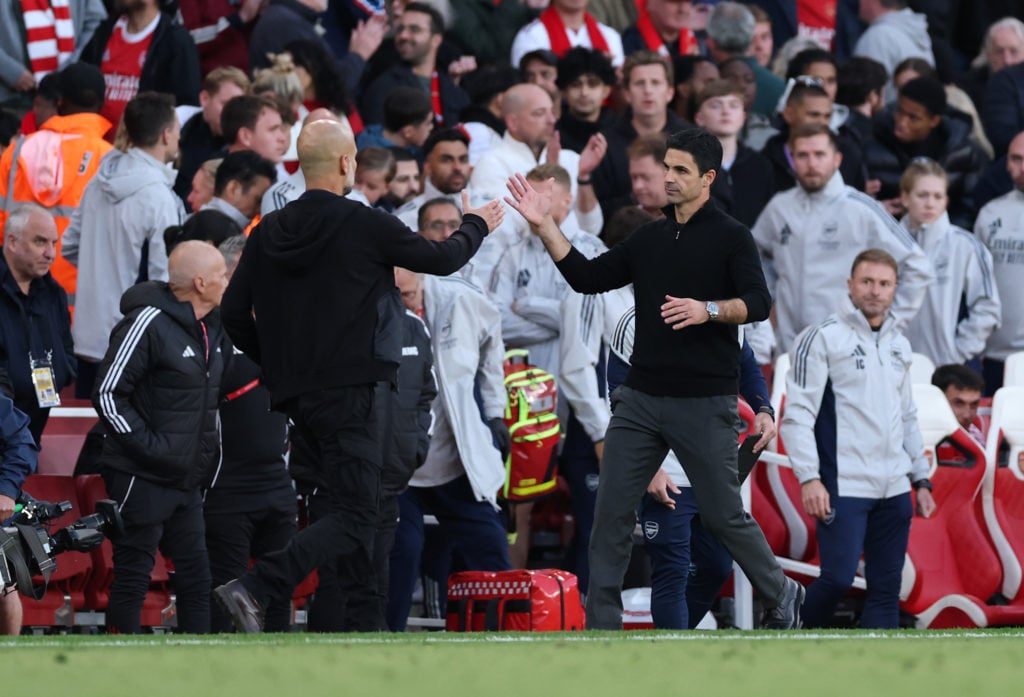 Pep Guardiola, Manager of Manchester City, and Mikel Arteta, Manager of Arsenal, shake hands following the Premier League match between Arsenal and Manchester City.