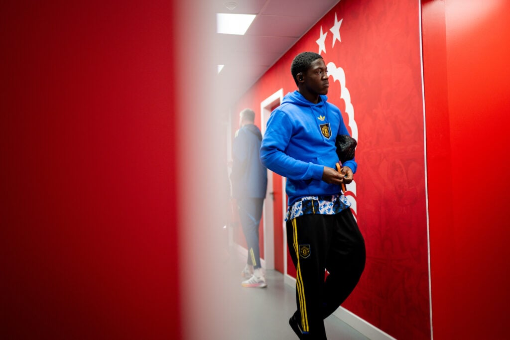 Kobbie Mainoo arrives at City Ground in Manchester United hoodie.
