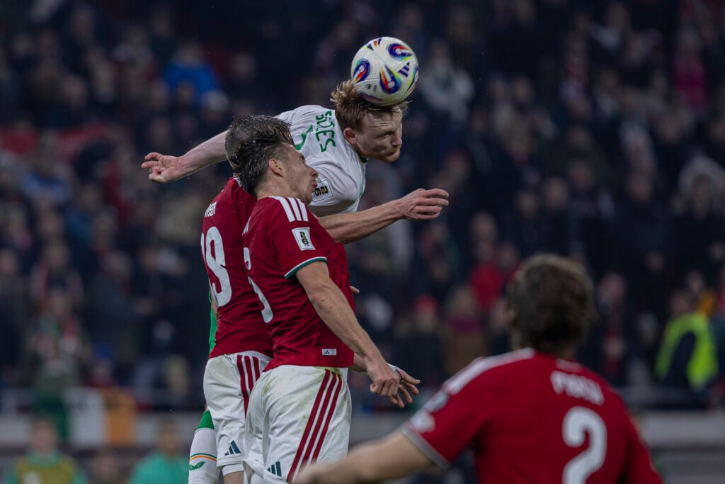 Liam Scales wins a header for the Republic of Ireland against Hungary in their FIFA World Cup 2026 Qualifier.