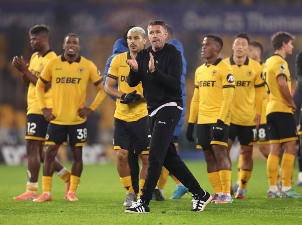 Rob Edwards claps fans with the Wolves players.