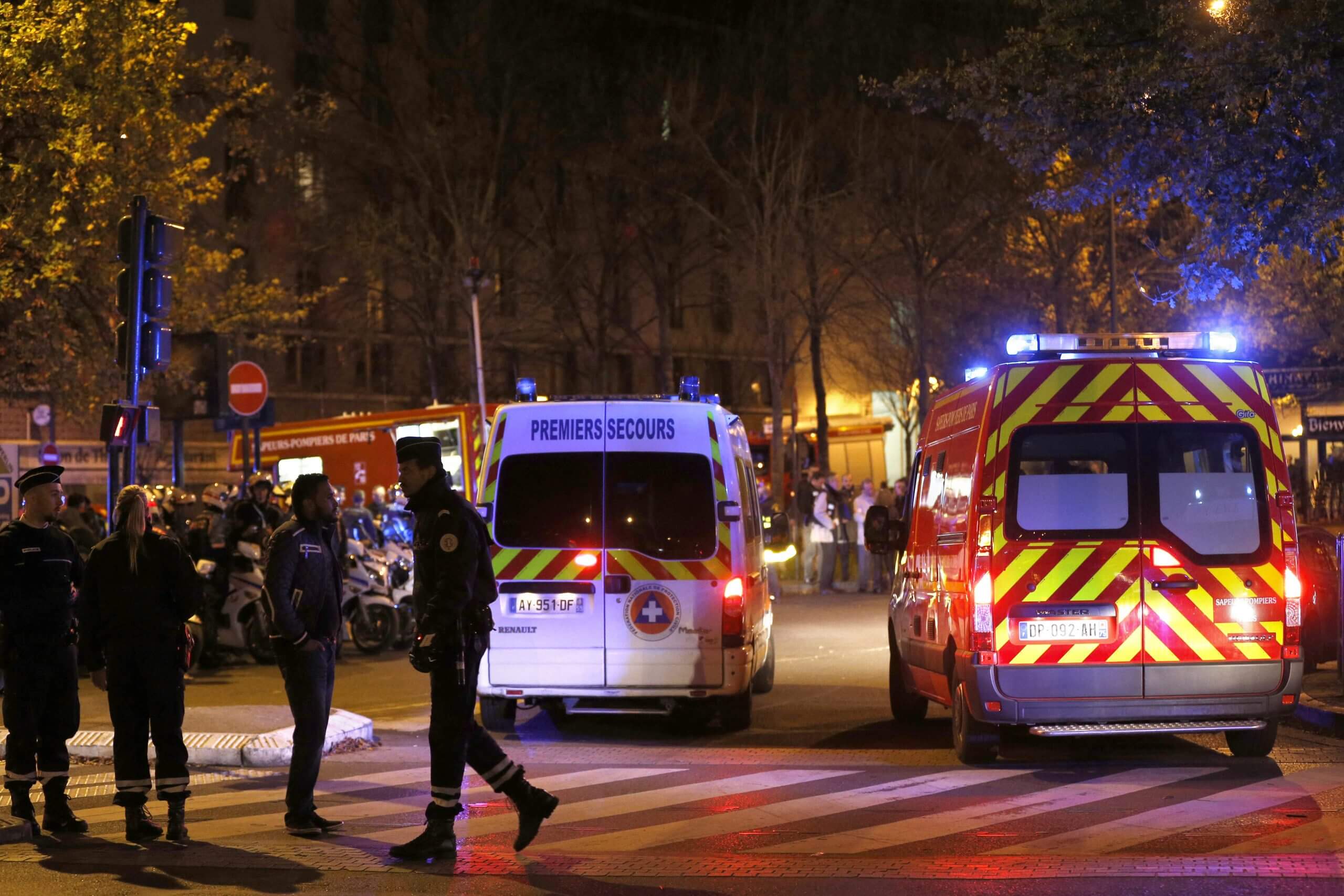 Rescuers and police gather outside the Stade de France 
