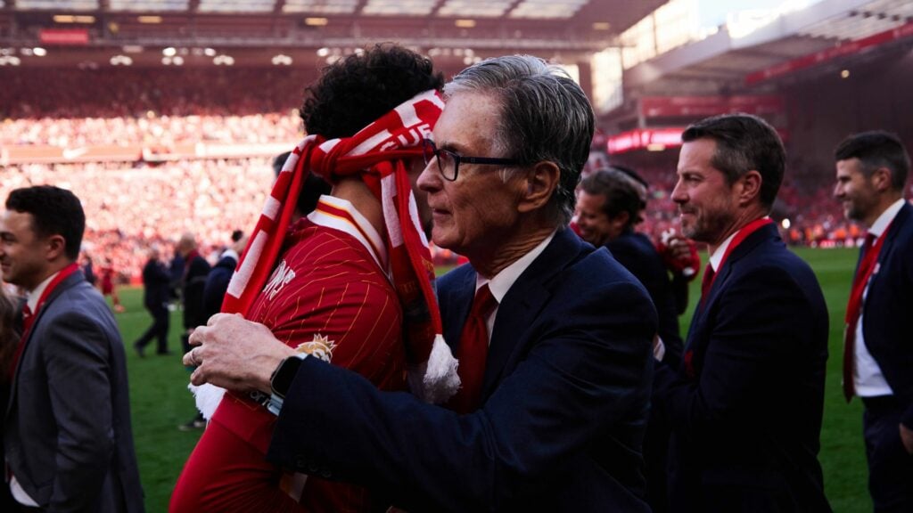 Liverpool owner John Henry hugs a player