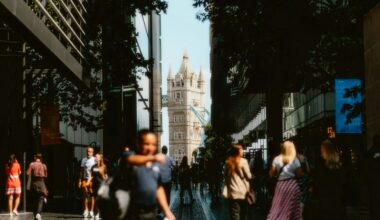 A picture of Tower bridge with crowds of people in the sunshine. Photo by Alin Gavriliuc on Unsplash