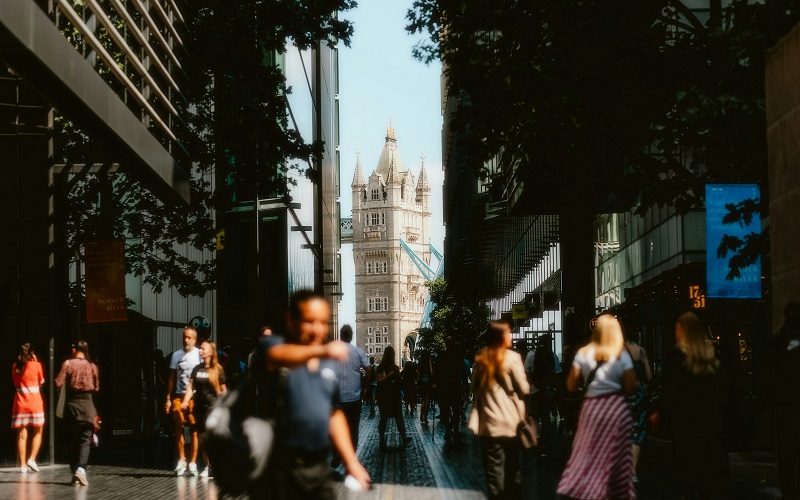 A picture of Tower bridge with crowds of people in the sunshine. Photo by Alin Gavriliuc on Unsplash