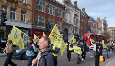 London bus drivers march to TfL headquarters carrying flags and banners.