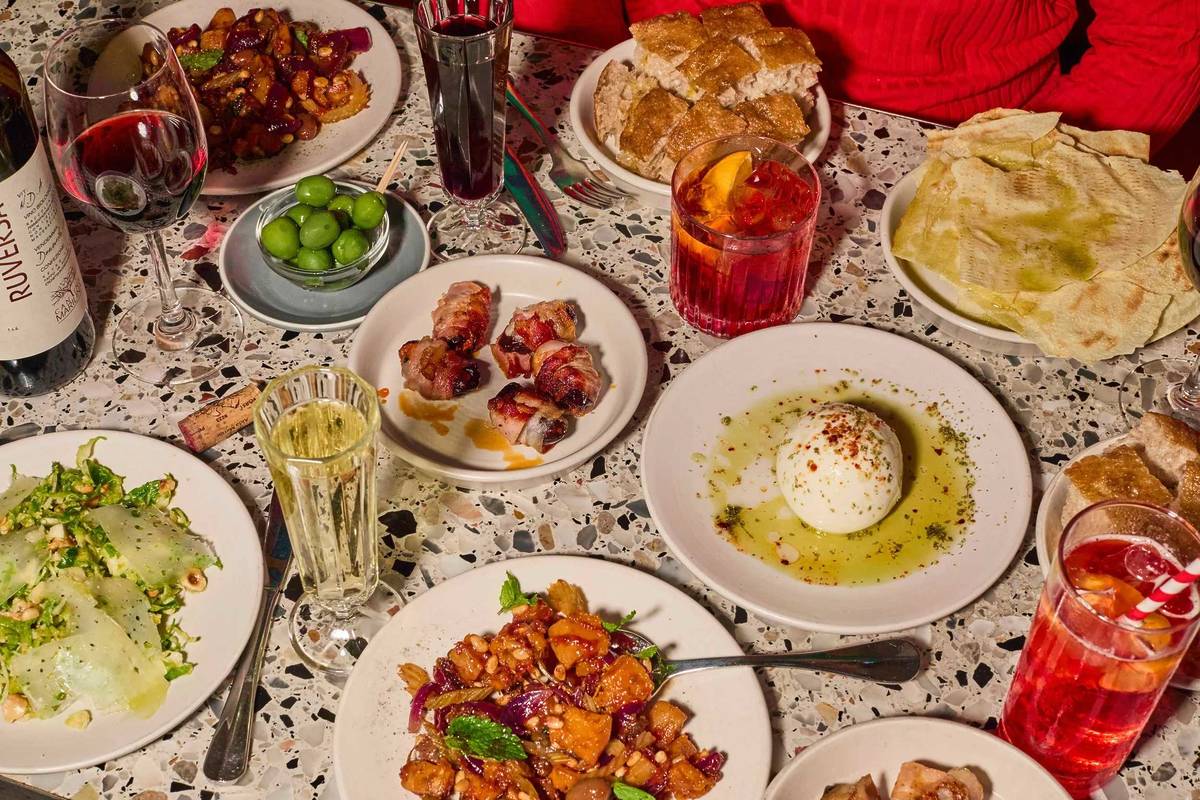 a table full of bowls of pasta and burrata at Pastaio