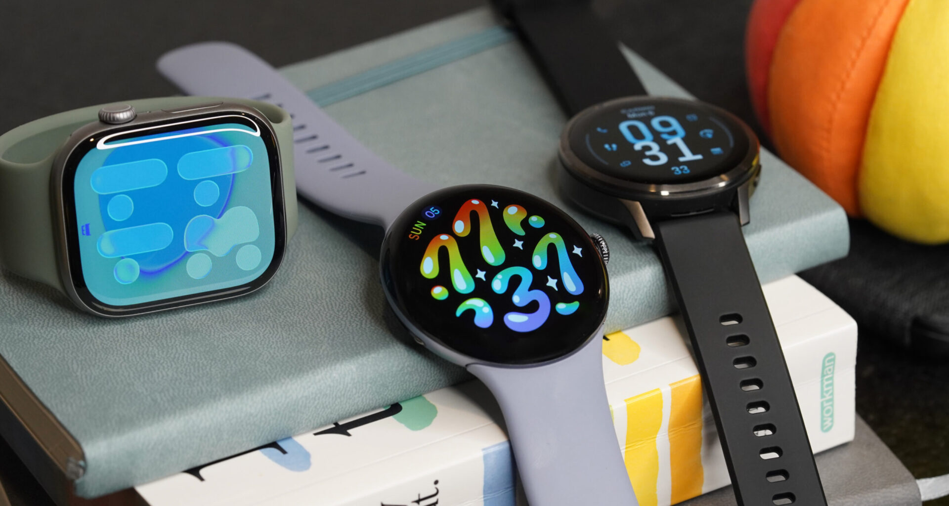 A Pixel Watch 4 rests on a pile of books with smartwatch alternatives.
