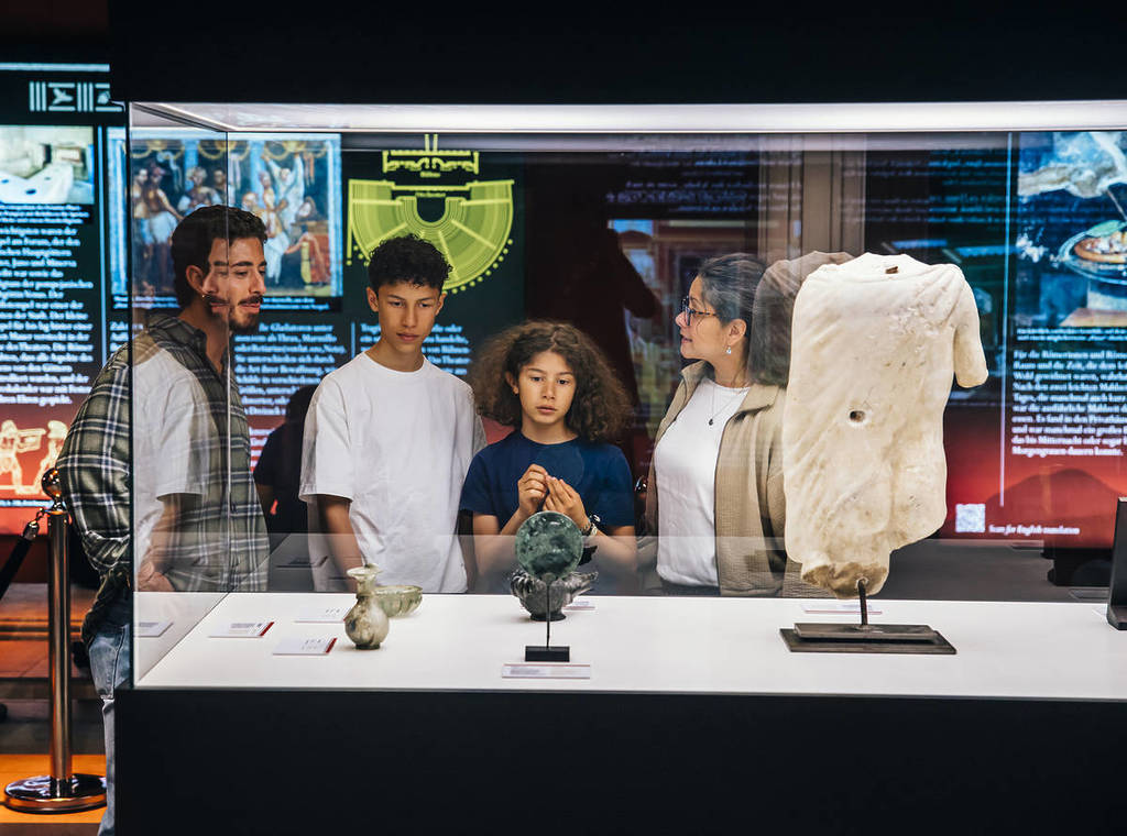 people look at artefacts at The Last Days of Pompeii: The Immersive Exhibition