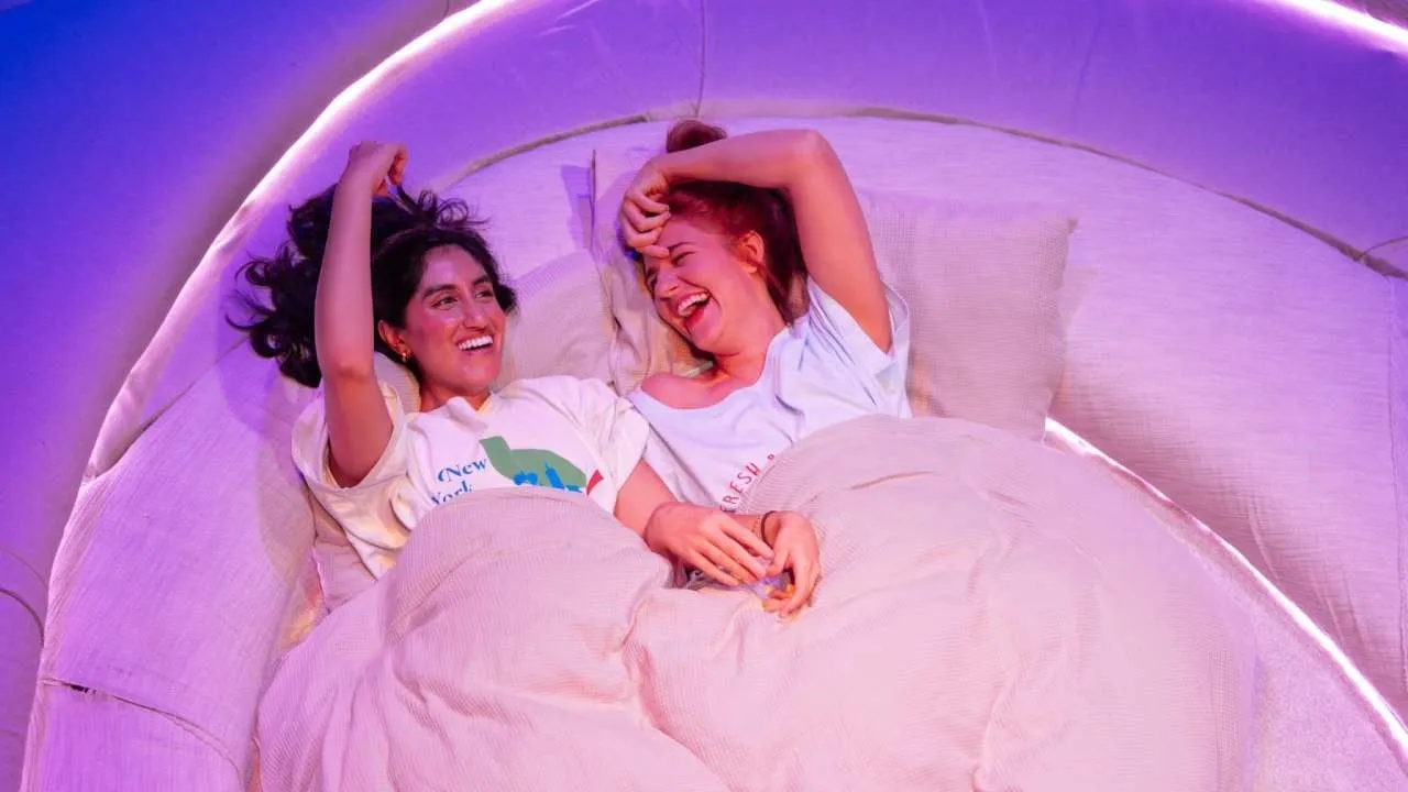 Two women laughing in bed. Porn Play - Royal Court Theatre London. Photo by Helen Murray