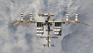 A photo of a large space station with various solar panels floating above Earth.
