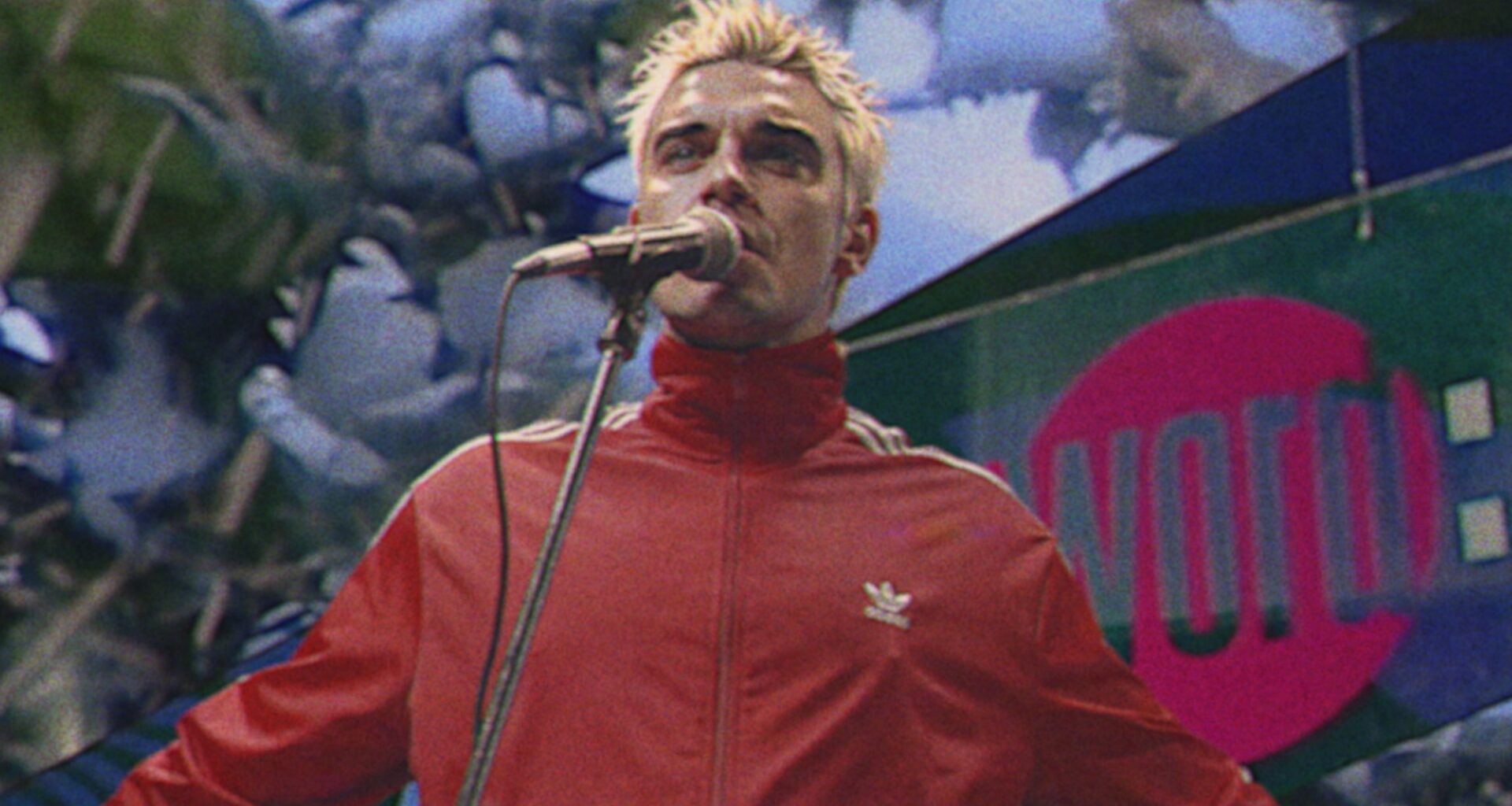 Watch Robbie Williams travel back in time to perform on 'The Word' for new 'Pretty Face' video