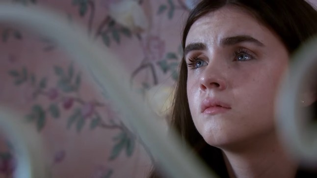 A close-up of April Windsor in Emmerdale, looking sad with tears in her eyes.