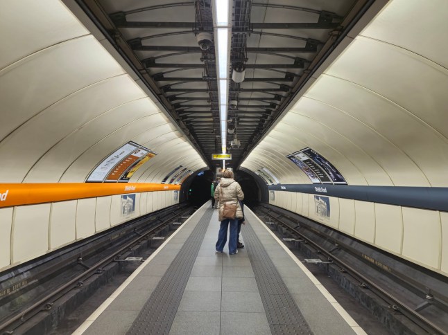 People waiting at underground station platform, Glasgow, Scotland UK