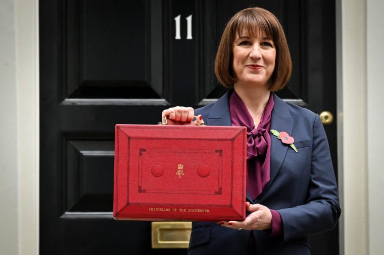 Britain's Chancellor of the Exchequer Rachel Reeves poses with the red Budget Box as she leaves 11 Downing Street, in central London, on October 30, 2024, to present the government's annual Autumn budget to Parliament. Britain's new Labour government unveils its first budget on Wednesday, the highly-anticipated fiscal update, the first under the centre-left government after 14 years of Conservative rule. (Photo by Justin TALLIS / AFP) (Photo by JUSTIN TALLIS/AFP via Getty Images)