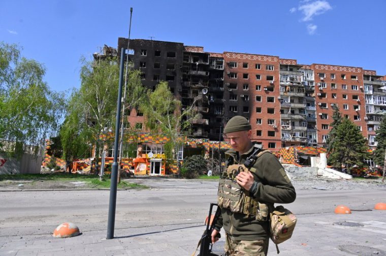 FILE - A Ukrainian soldier walks past damaged buildings in central Pokrovsk, in the Donetsk region of Ukraine, April 23, 2025. (AP Photo/Michael Shtekel, File)