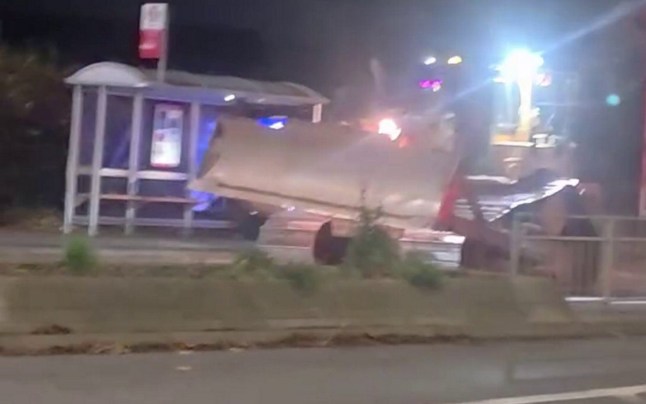 A bulldozer ploughing through a Royal Mail lorry. // This is the moment a bulldozer ploughed through a Royal Mail lorry as stunned onlookers watched in shock. Footage, taken in Wolverhampton, West Mids., shows the huge lorry parked across Willenhall Road - moments before the crash. Crowds gathered on the pavement, filming as a helicopter hovered overhead and officers ran along the road at around 7pm last night (November 8). Moments later, members of the public could be heard shouting about a 