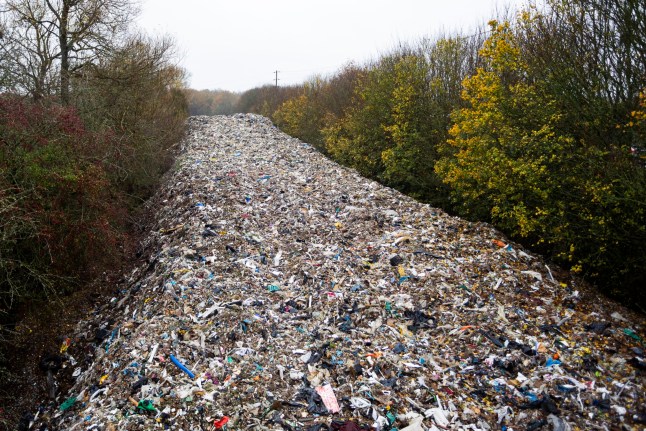 Shocking pictures show Britain's biggest ever fly tip - a pile of waste 500FT long dumped in one go. The massive heap of hazardous rubbish stretches 150m and is around 20ft (6m) deep. It was illegally dumped in a field next to the A34 and River Cherwell near Kidlington in Oxfordshire. The waste was left in one go and described by an MP as "threatening an environmental disaster". Kidlington, Oxfordshire. November 14 2025. // Shocking pictures show Britain's biggest ever fly tip - a pile of waste 500FT long dumped in one go. The massive heap of hazardous rubbish stretches 150m and is around 20ft (6m) deep. It was illegally dumped in a field next to the A34 and River Cherwell near Kidlington in Oxfordshire. The waste was left in one go and described by an MP as "threatening an environmental disaster". Photo released 14/11/2025